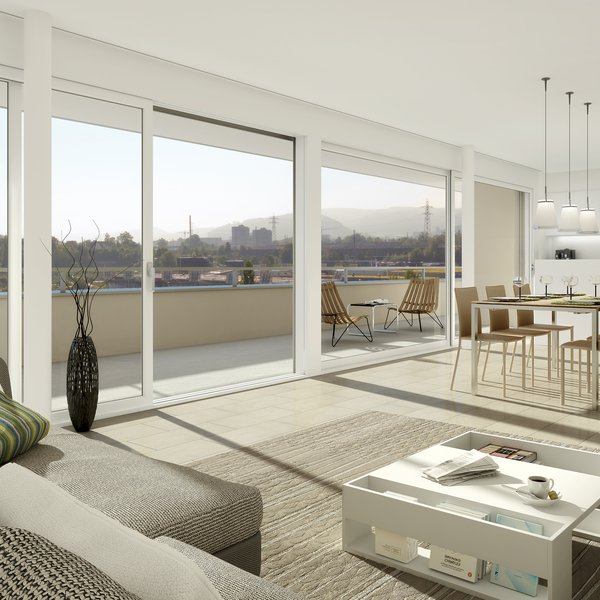 Es ist ein Wohnbereich einer Casavita-Wohnung mit Terrasse, offener Küche und grossen Fensterfronten zu sehen.