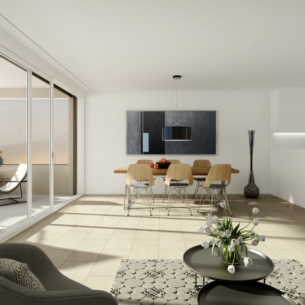 Es ist ein Wohnbereich einer Casavita-Wohnung mit Terrasse, offener Küche, Esstisch, Sofa, Sessel und grossen Fensterfronten zu sehen.